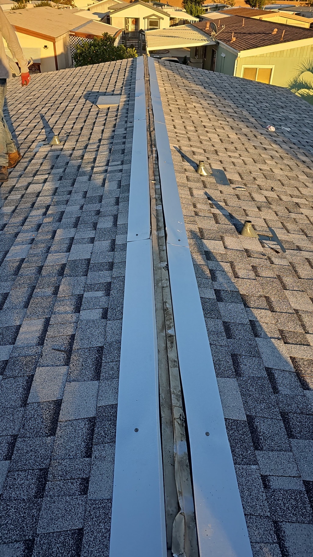 Metal ridge vent installed along the ridge of a San Diego shingle roof
