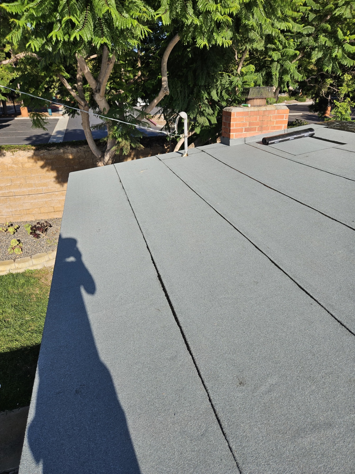 Finished gray Polyglass torch-down low-slope roof in San Diego