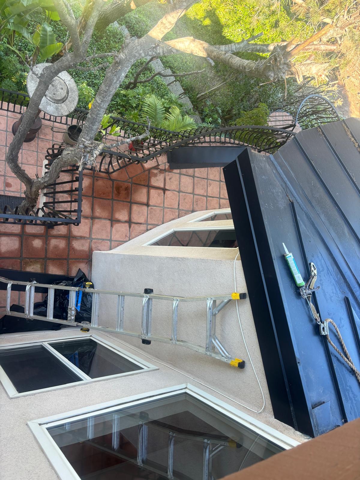 Overhead view of completed metal fascia replacement around skylights on a San Diego home
