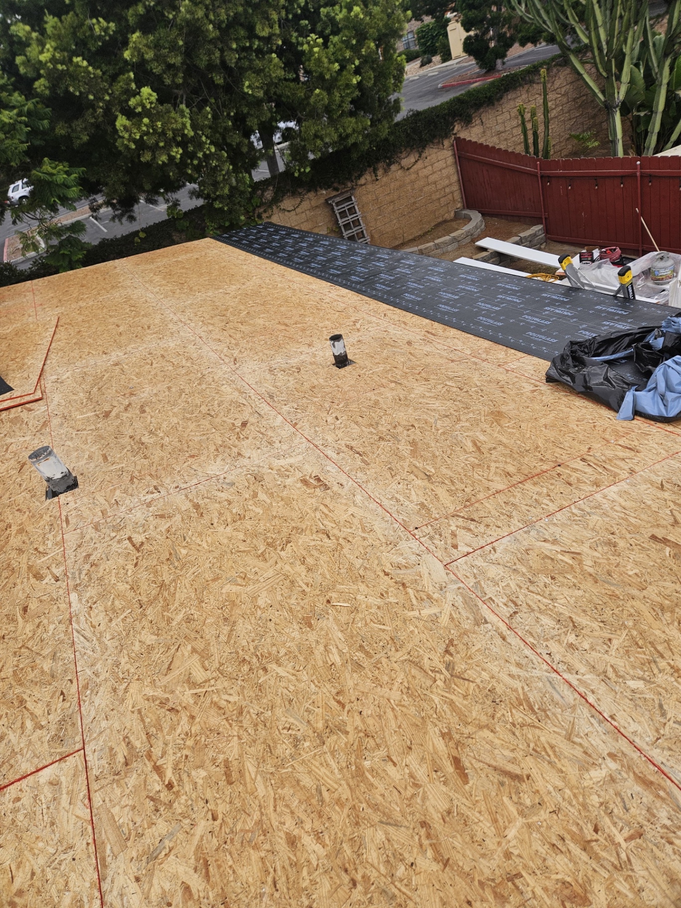 New plywood roof deck installed above polyiso insulation in San Diego