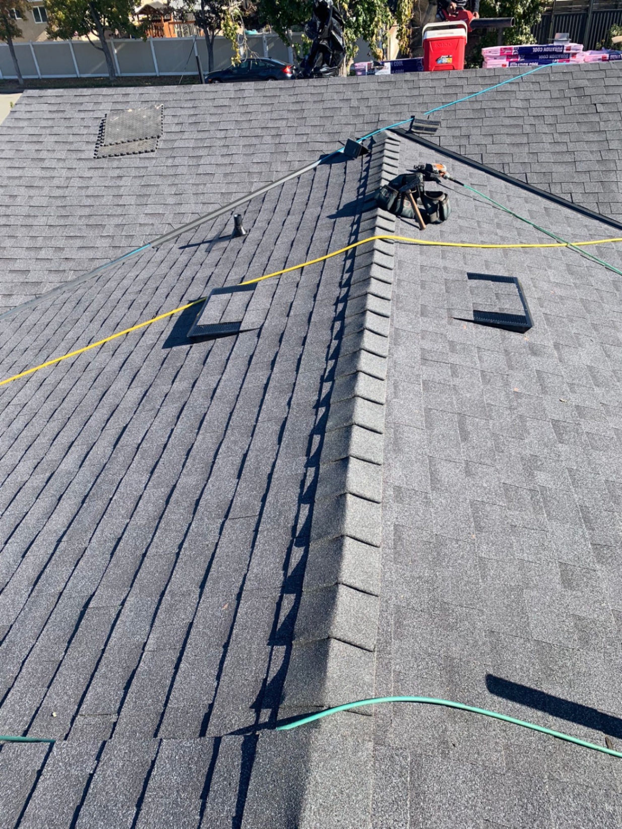 Completed architectural shingle roof with ridge cap and attic vents in San Diego County