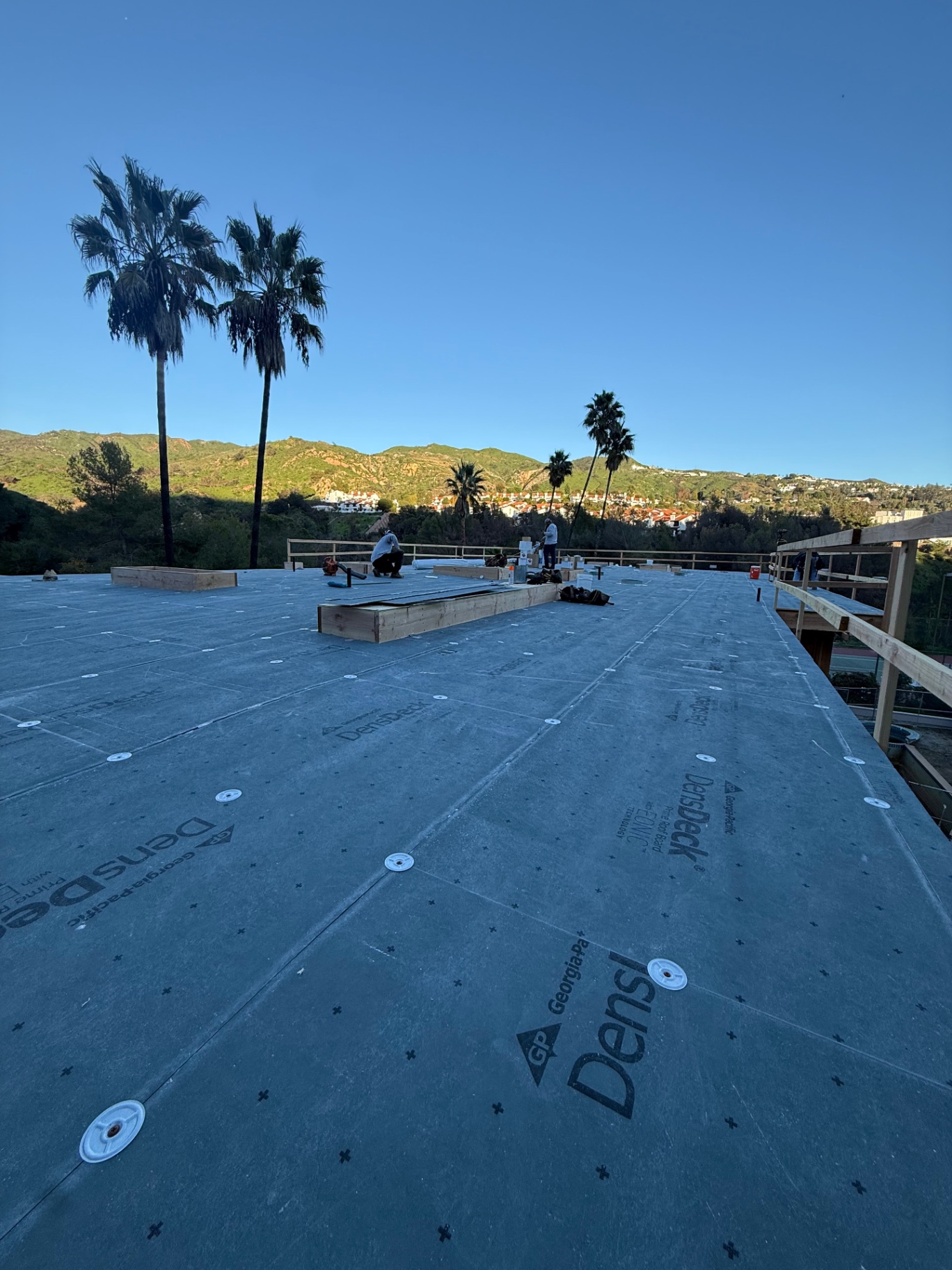 DensDeck cover board fastened over a commercial low-slope roof deck in San Diego County