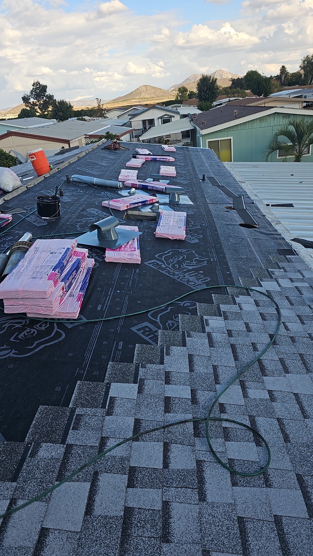 Owens Corning Duration COOL shingles staged over new underlayment on a San Diego re-roof