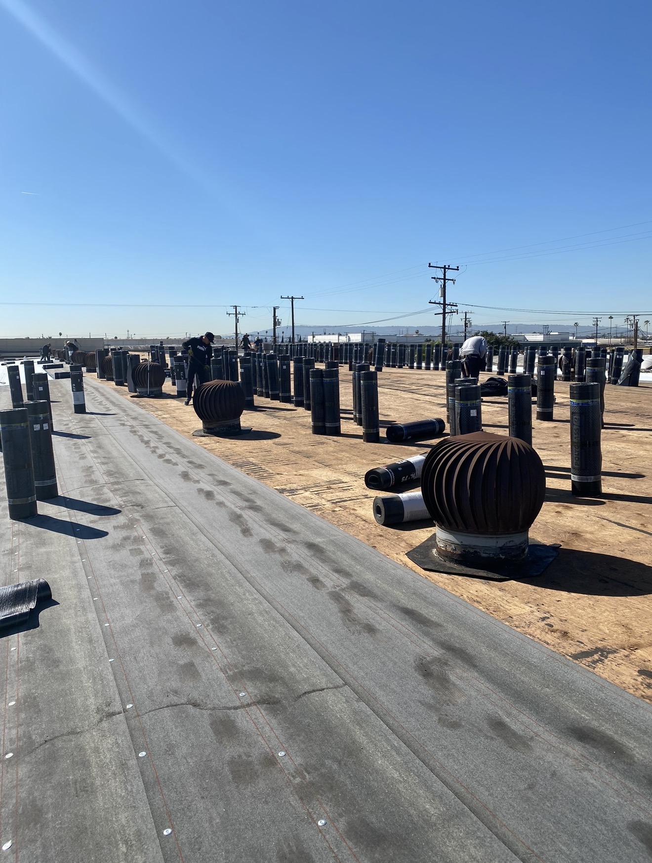 Crew installing a commercial flat roof in Escondido