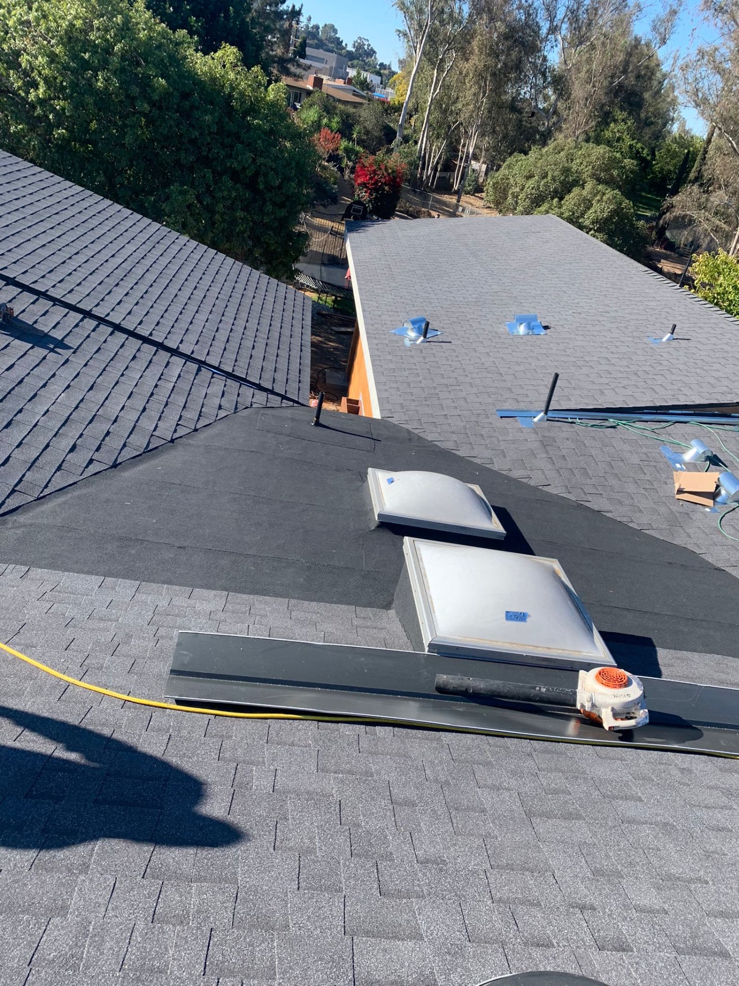 New shingle roof with skylights and new metal drip edge on a San Diego hillside home