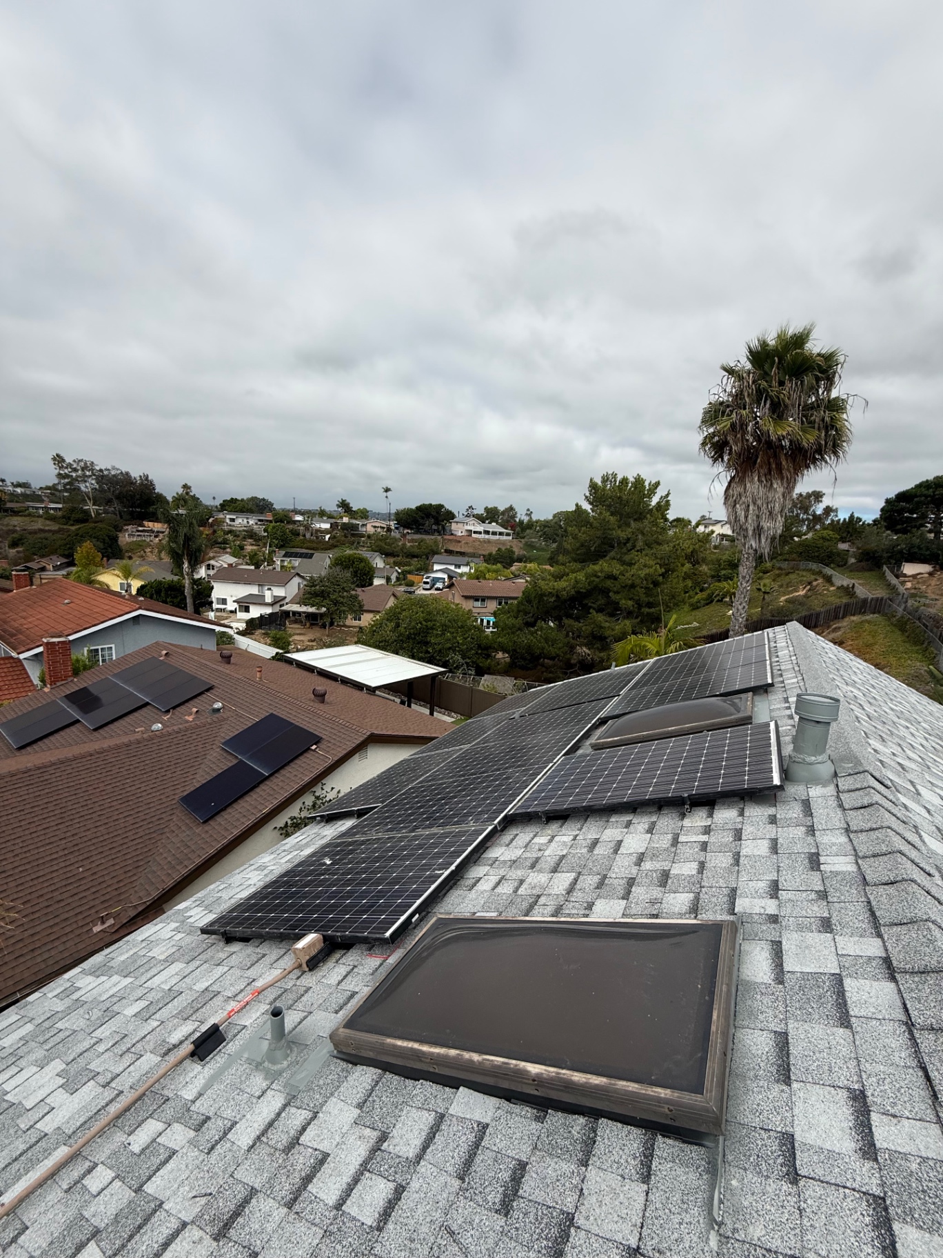 Completed San Diego roof replacement with architectural shingles and reinstalled solar panels