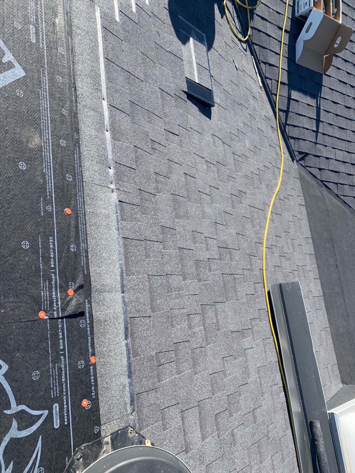 Close-up of new architectural shingle courses and ridge vent on a San Diego roof