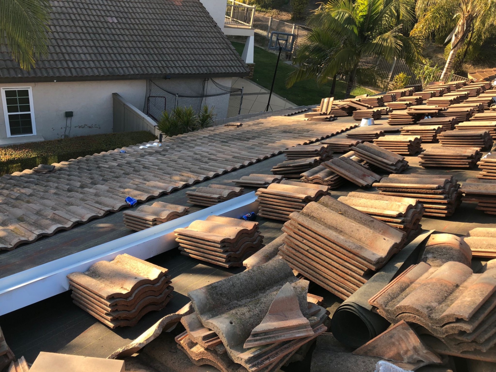 Concrete roof tiles stacked on a San Diego home during a lift and relay re-roof