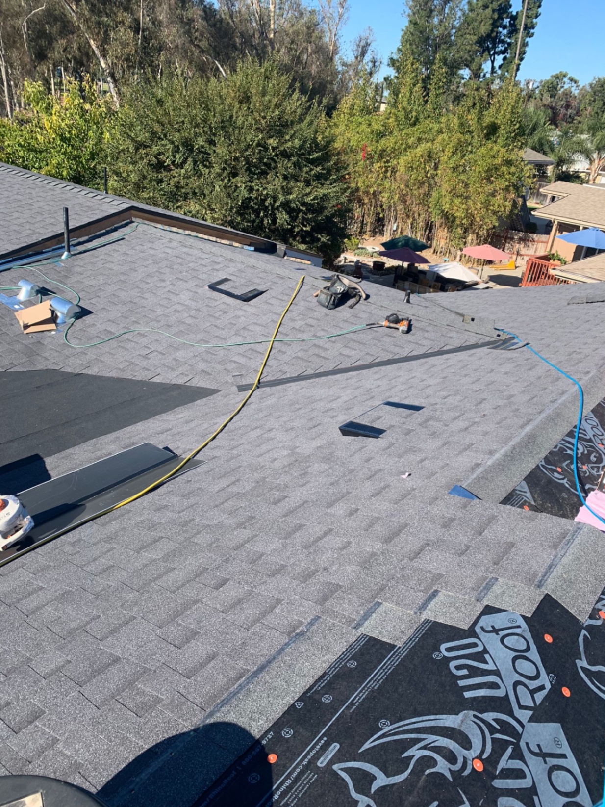 Shingle installation in progress over synthetic underlayment on a San Diego roof