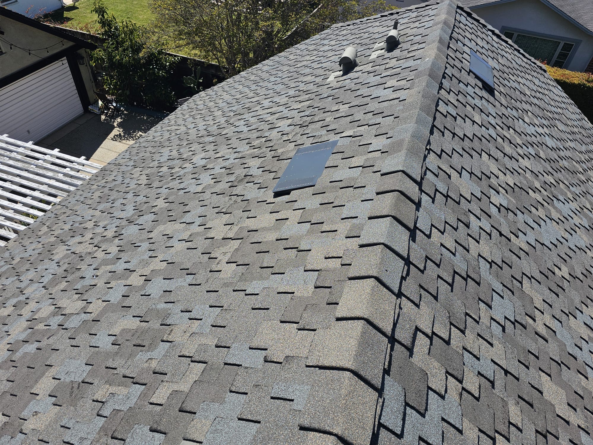 New architectural shingle roof in San Diego with re-flashed pipe vents and attic vent