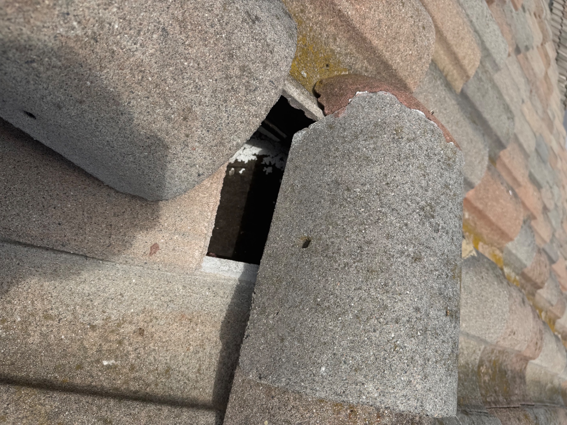 Broken concrete roof tile leaving an open gap down to the roof deck on a San Diego home