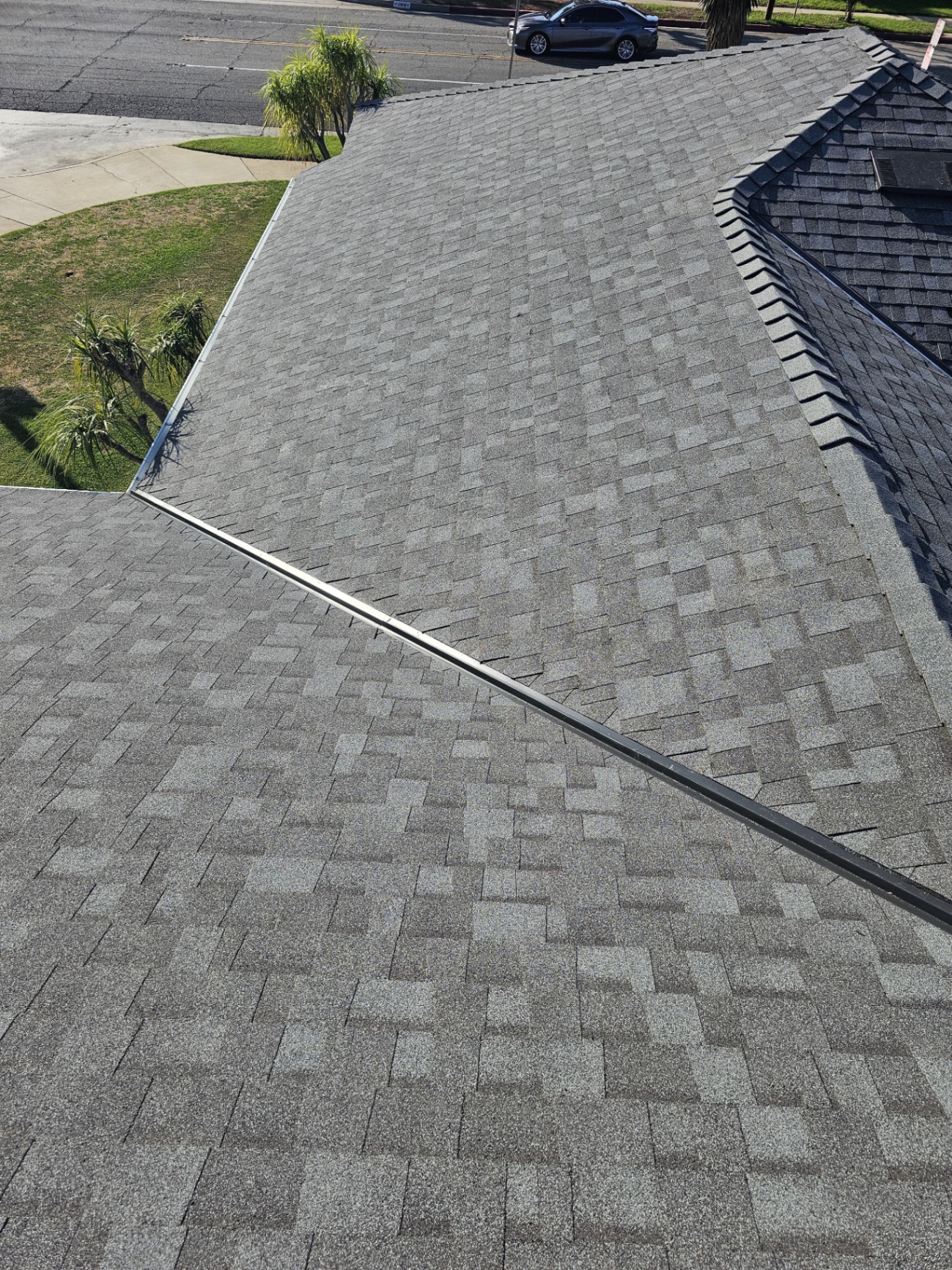 Wide view of a completed architectural shingle roof and valley in San Diego