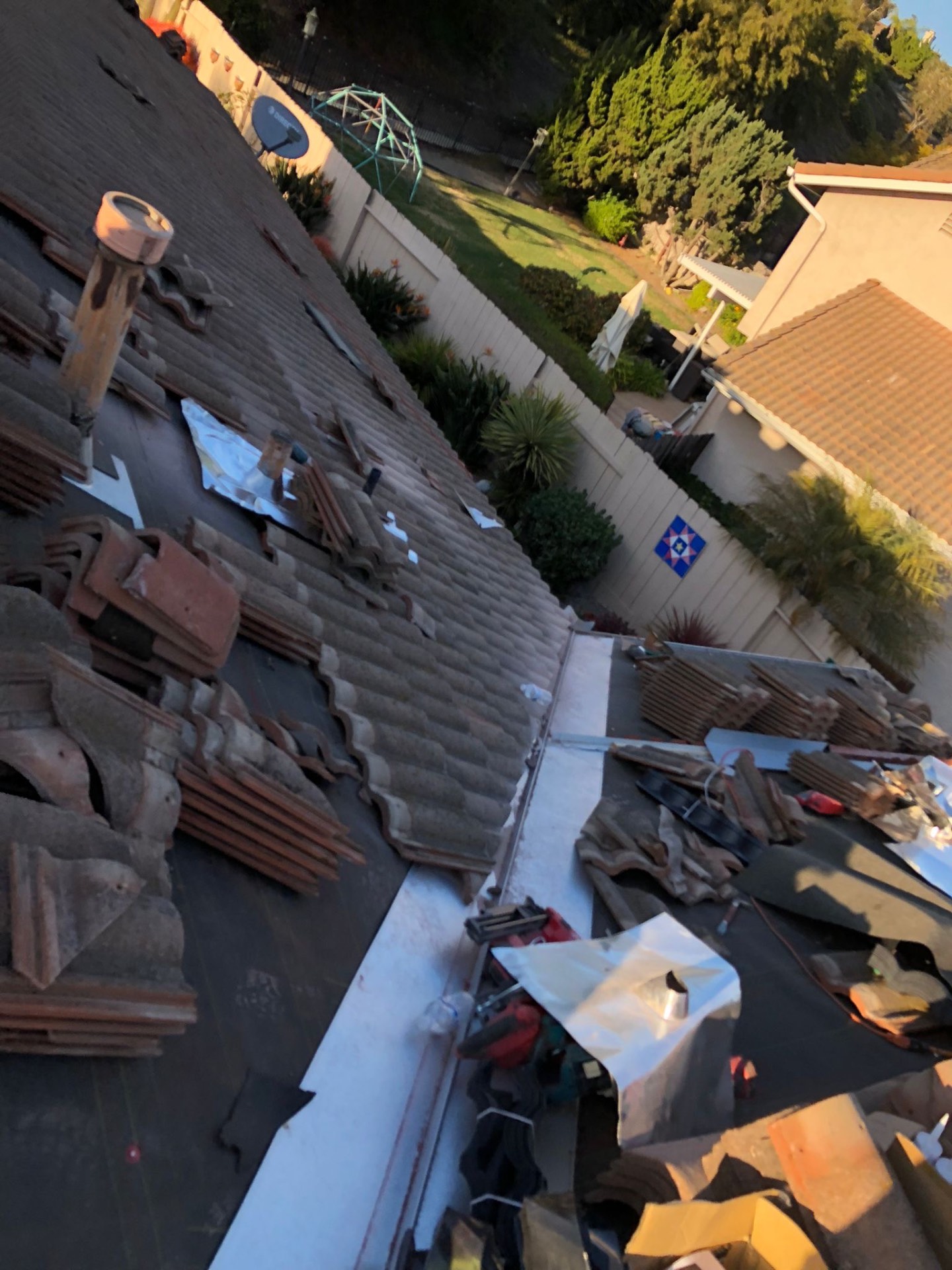 Tile roof stripped to underlayment with new valley metal and flashings in San Diego