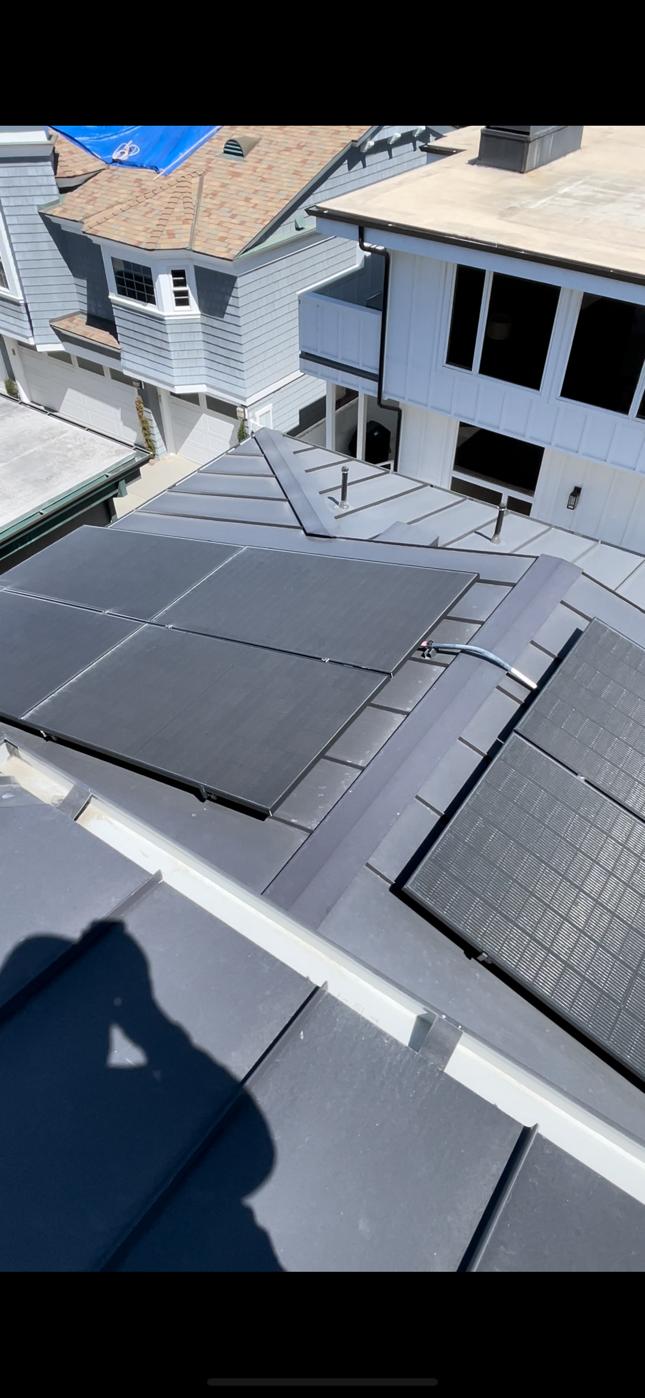 Solar panels mounted on a standing seam metal roof with seam clamps in San Diego