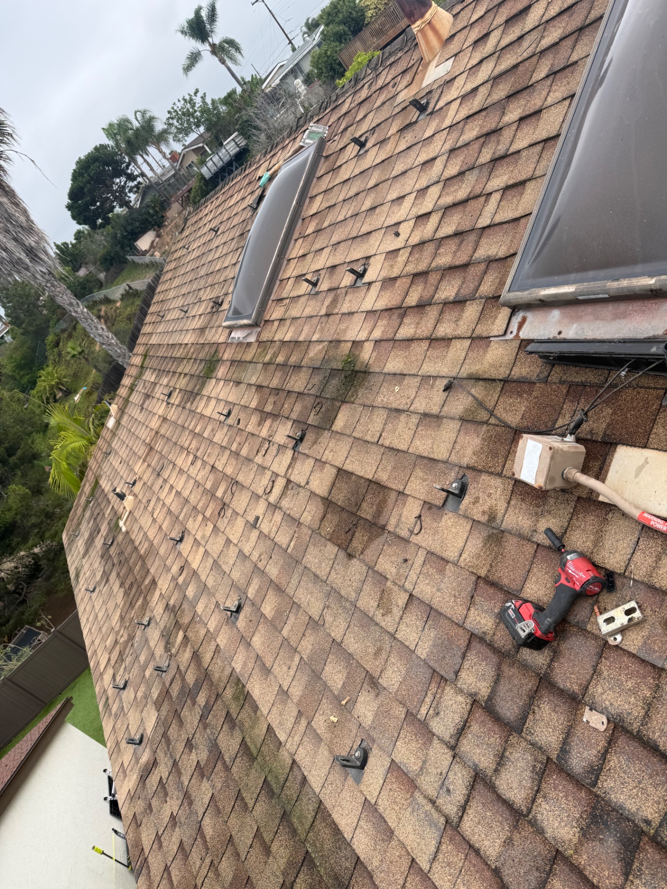 Residential roof after solar panels and mounting hardware were removed for roof replacement